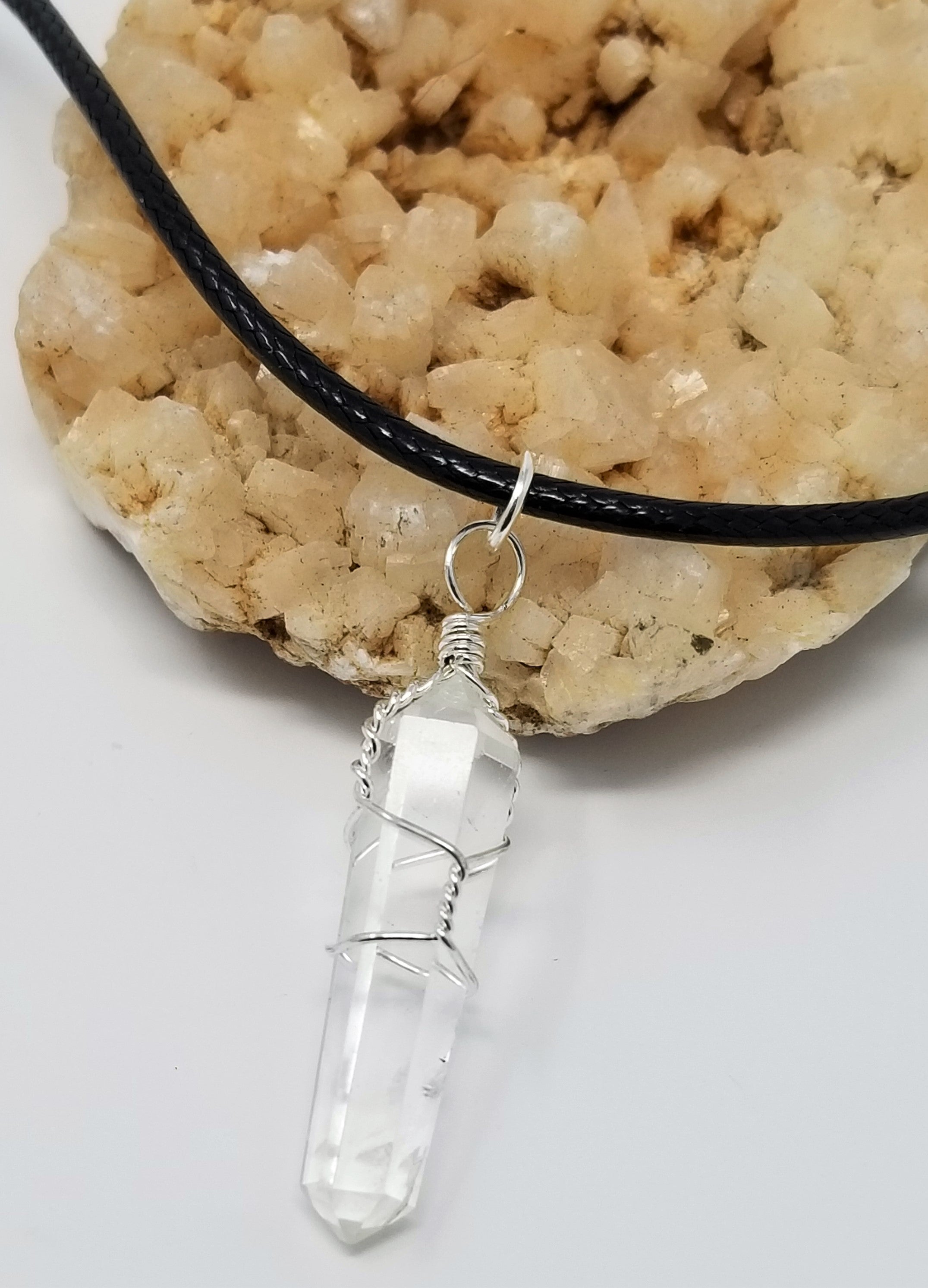 Hand Wrapped Crystal Quartz Point Hanging from a Waxed Linen Cord