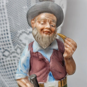 Vintage Figurine Man with Rifle Holding Bullet