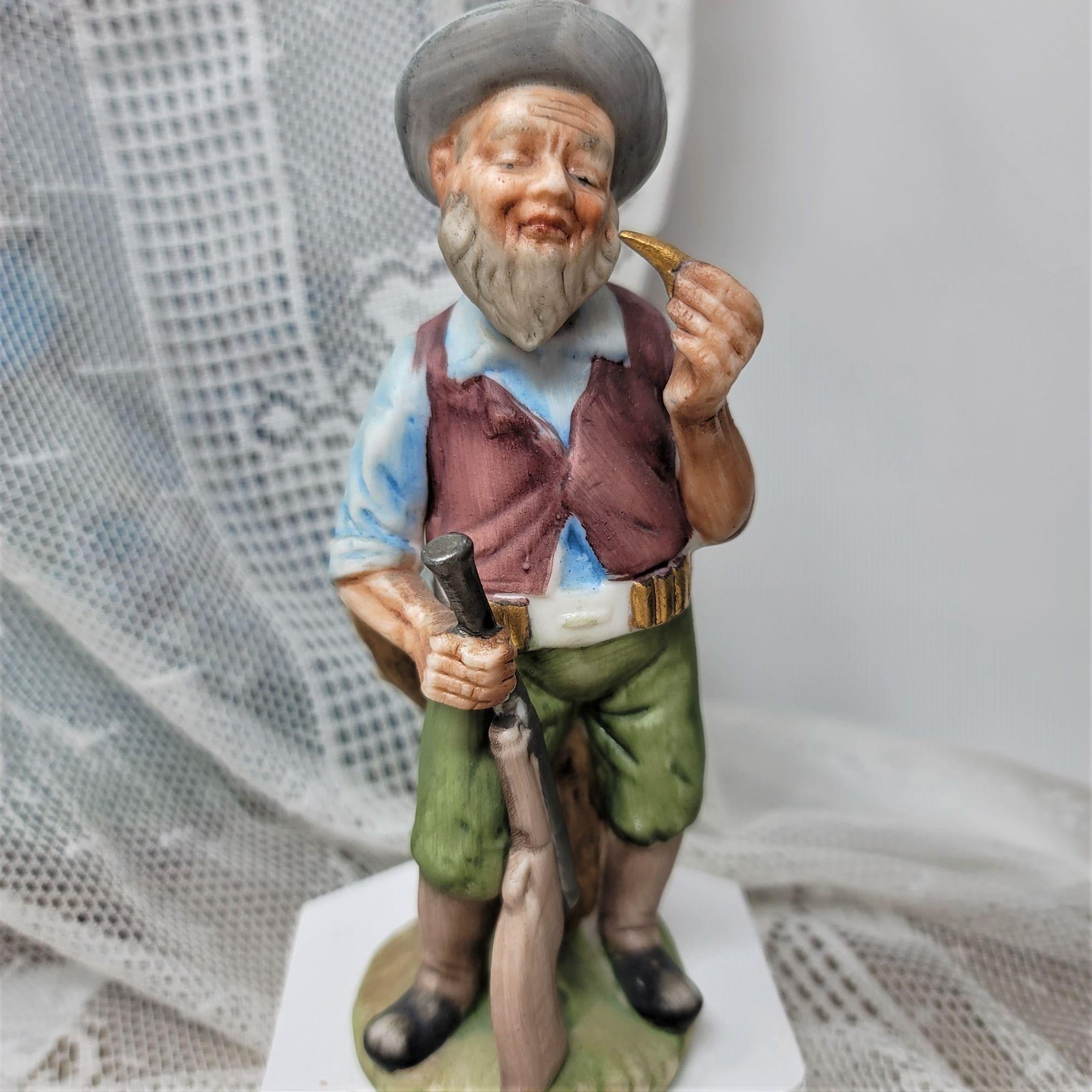 Vintage Figurine Man with Rifle Holding Bullet