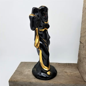 Mid Century Black & Gold Woman’s Figurine Carrying a Jar